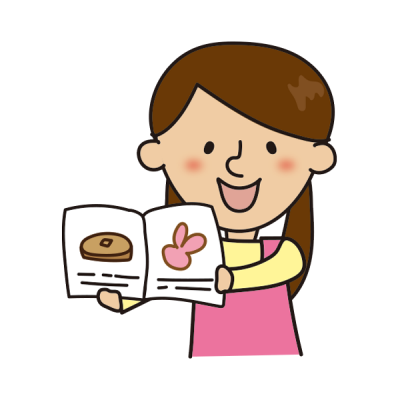 絵本を読む二つ結びの保育士