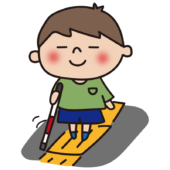 点字ブロックの上を歩く白杖を持った子供（男の子）