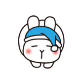 ナイトキャップをかぶってまるまって寝ている白いうさぎ