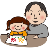 お絵描きをする娘と見守るパパ