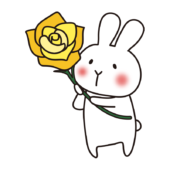 黄色い大きなバラを持っている白いうさぎ