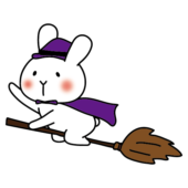 魔女の仮装でほうきに乗る白いうさぎ