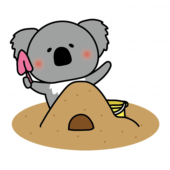 砂場で砂遊びをするコアラ