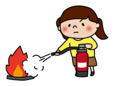 消火器を使って消火の練習をする子供（女の子）